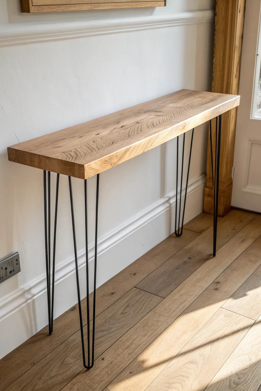 Slim oak console with matte black legs—modern rustic style that keeps entryways airy.