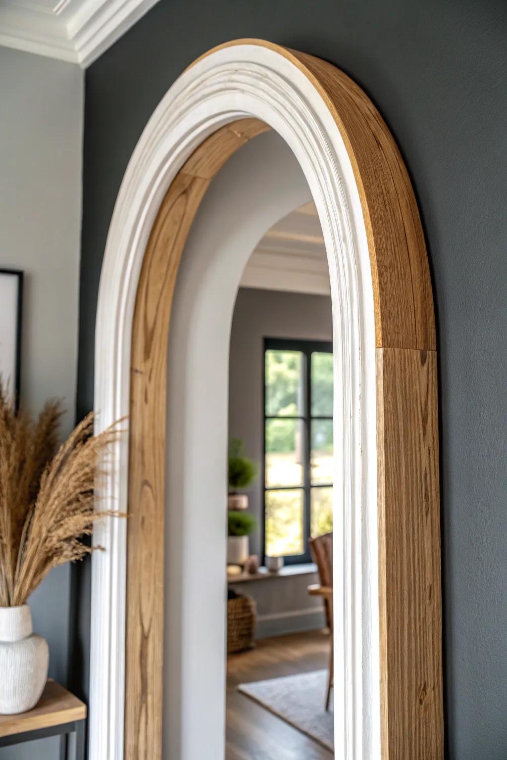 Crisp white painted arch trim against a moody wall—simple contrast that makes the curve pop.