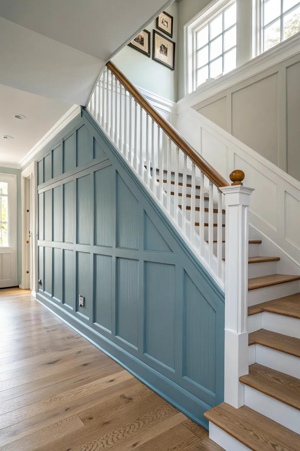 Blue stair-wall wainscoting: durable, handprint-proof, and a beautiful line guiding the eye upward.