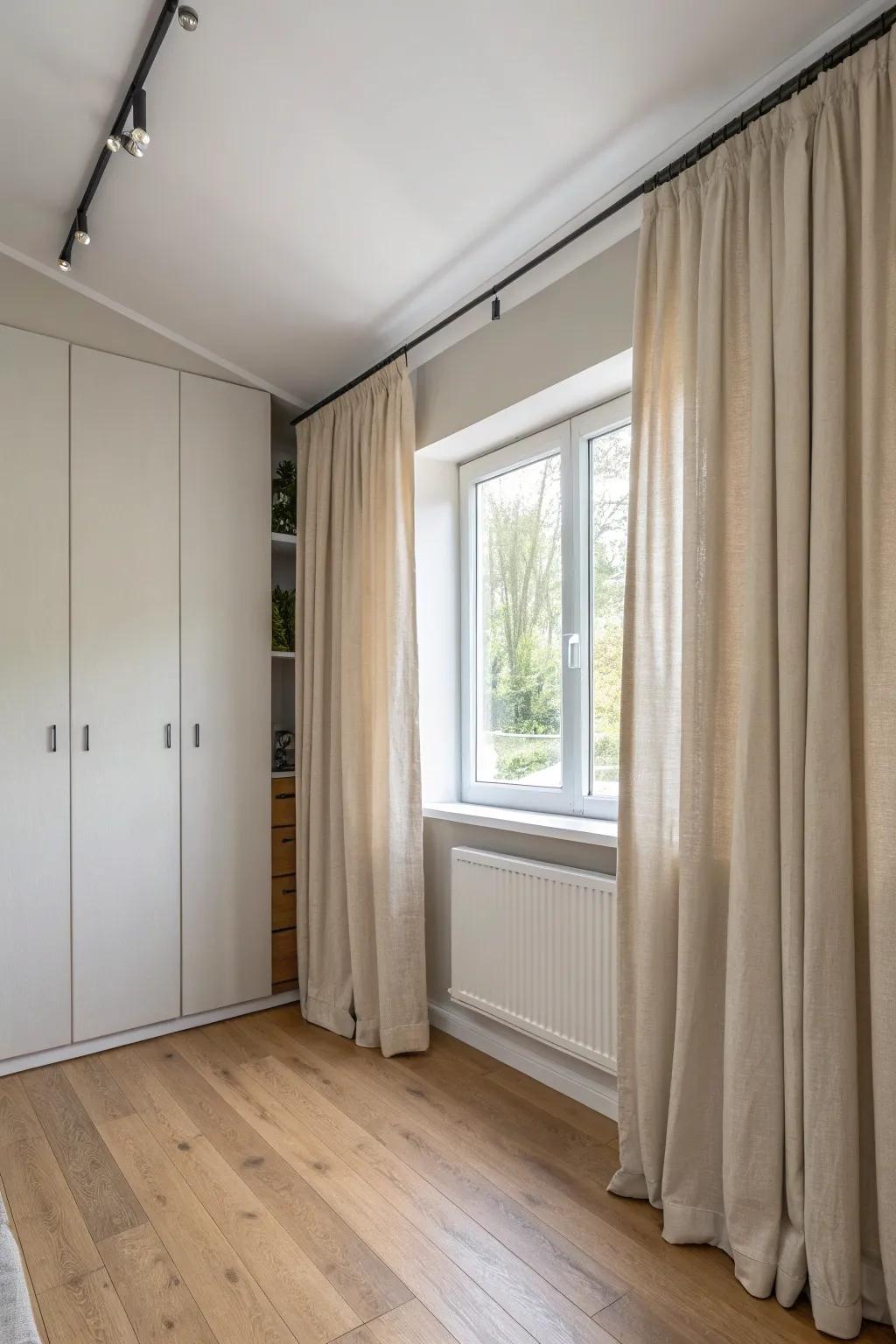 Ceiling-track linen curtains create a sleek, space-saving closet door with soft, airy height.