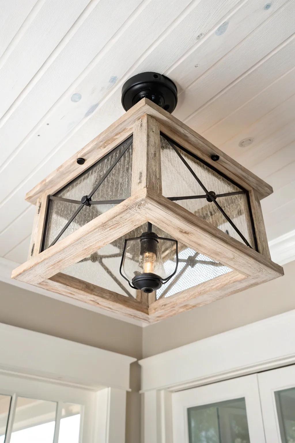 Whitewashed wood flush mount with dark hardware—bright, rustic contrast and visible grain.