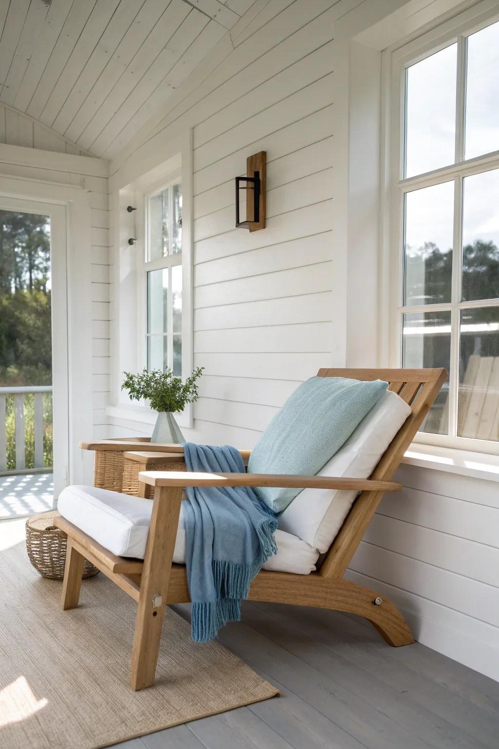 Soft coastal blues pop against crisp white shiplap for a calm, breezy sunroom moment.