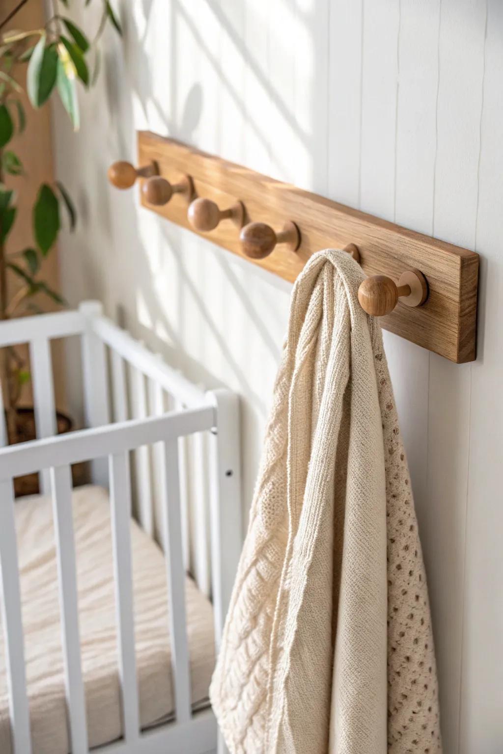 Reclaimed wood peg rail keeps tiny nursery essentials tidy—simple, warm, and beautiful.