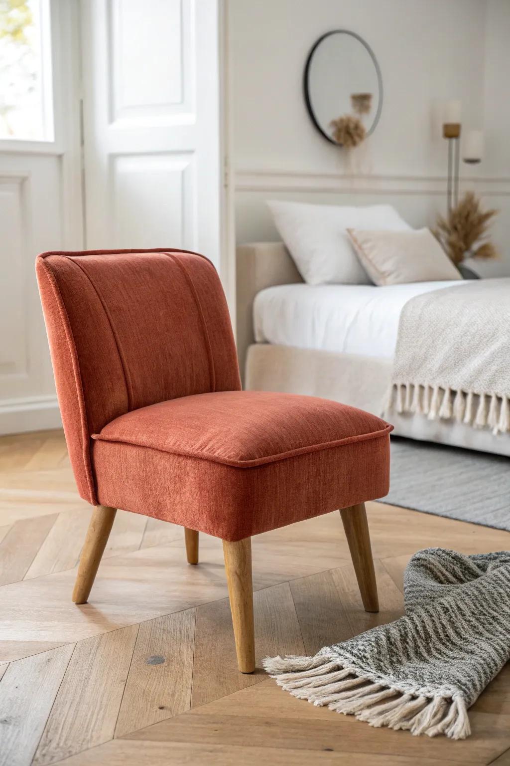 Petite terracotta slipper chair: low-profile comfort that finishes a small bedroom beautifully.