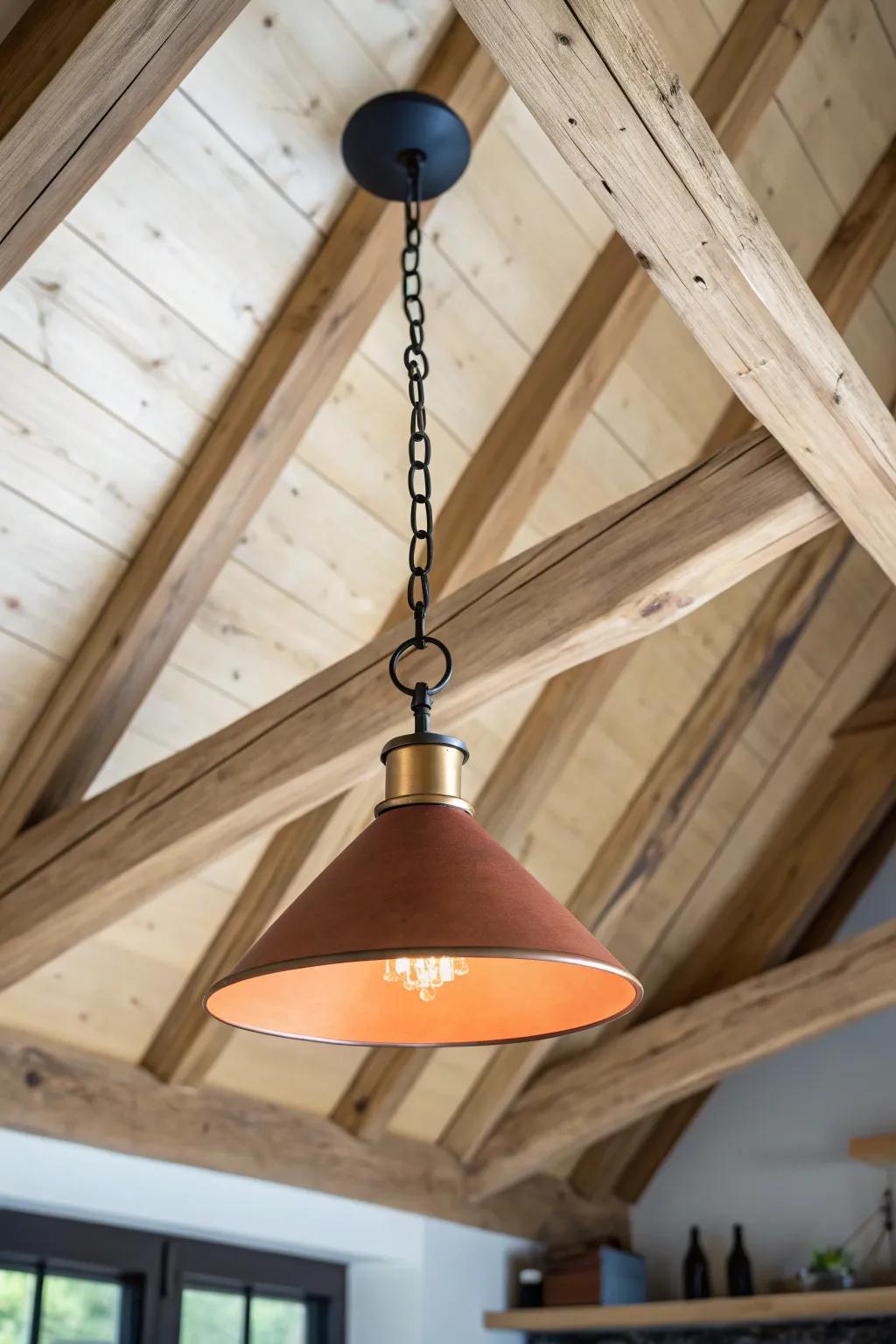A long-chain pendant drops from a vaulted log peak to anchor dining or lounge zones.