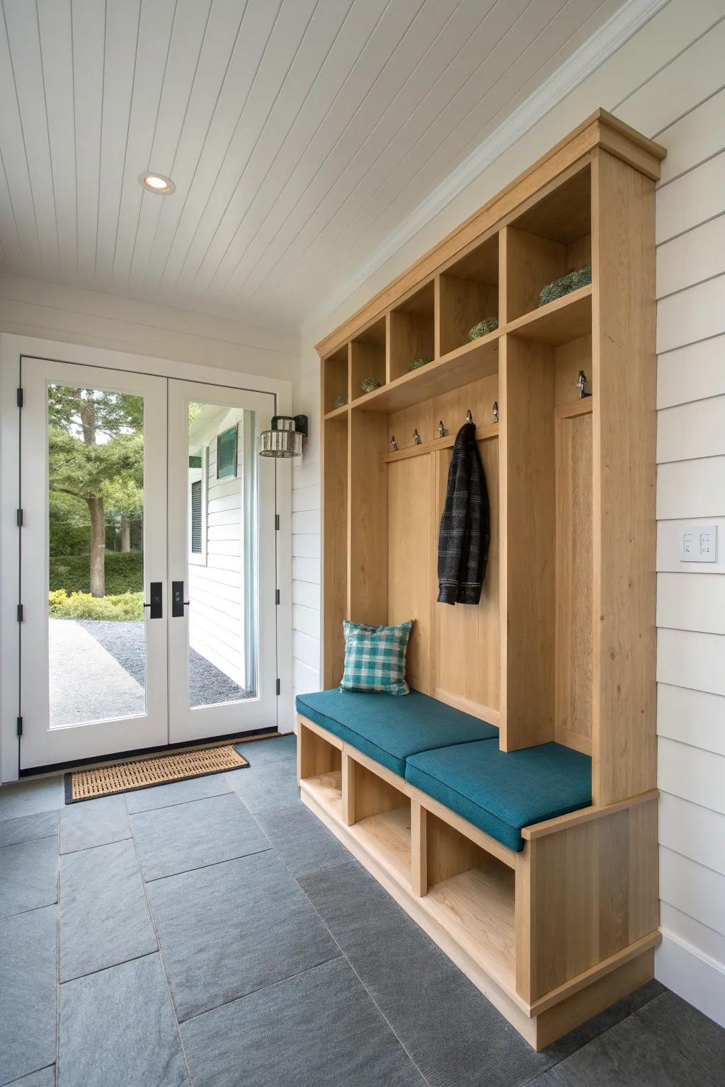 A sleek built‑in bench + cubbies turns the covered walkway into a calm, clutter‑free mudroom.