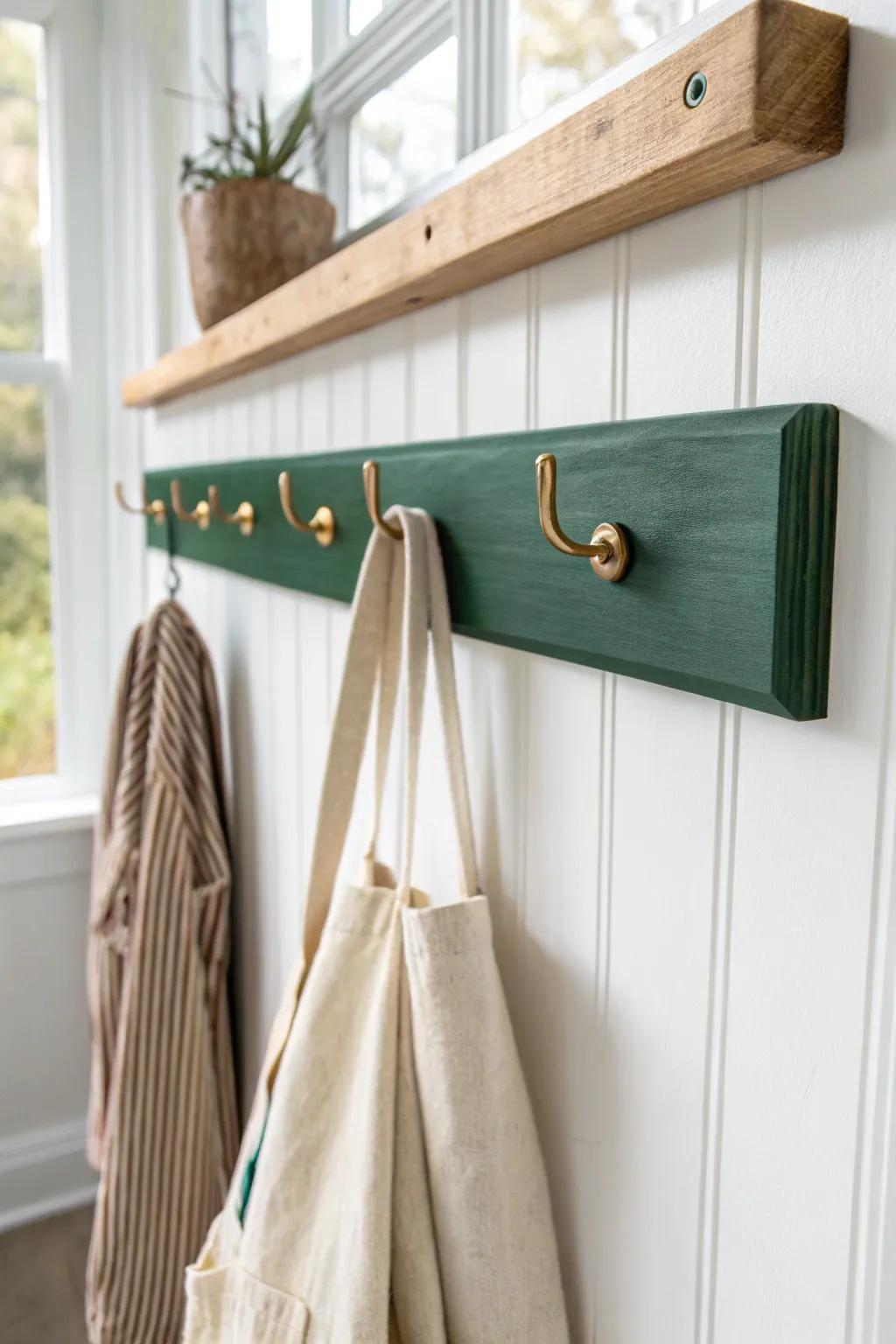 A forest-green peg rail in reclaimed wood—simple, built-in feel with artisan charm.
