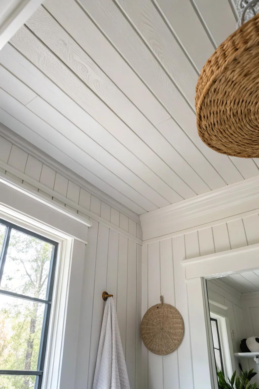 Crisp edge trim over shiplap creates a clean, custom bathroom ceiling finish with cozy charm.