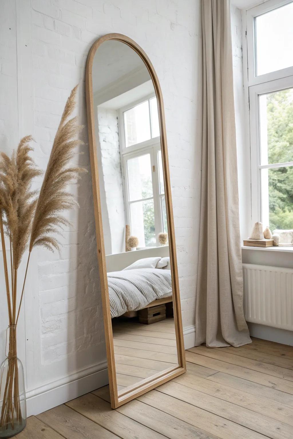 Lean an arched mirror to brighten your sleigh bed and add airy depth to the room.