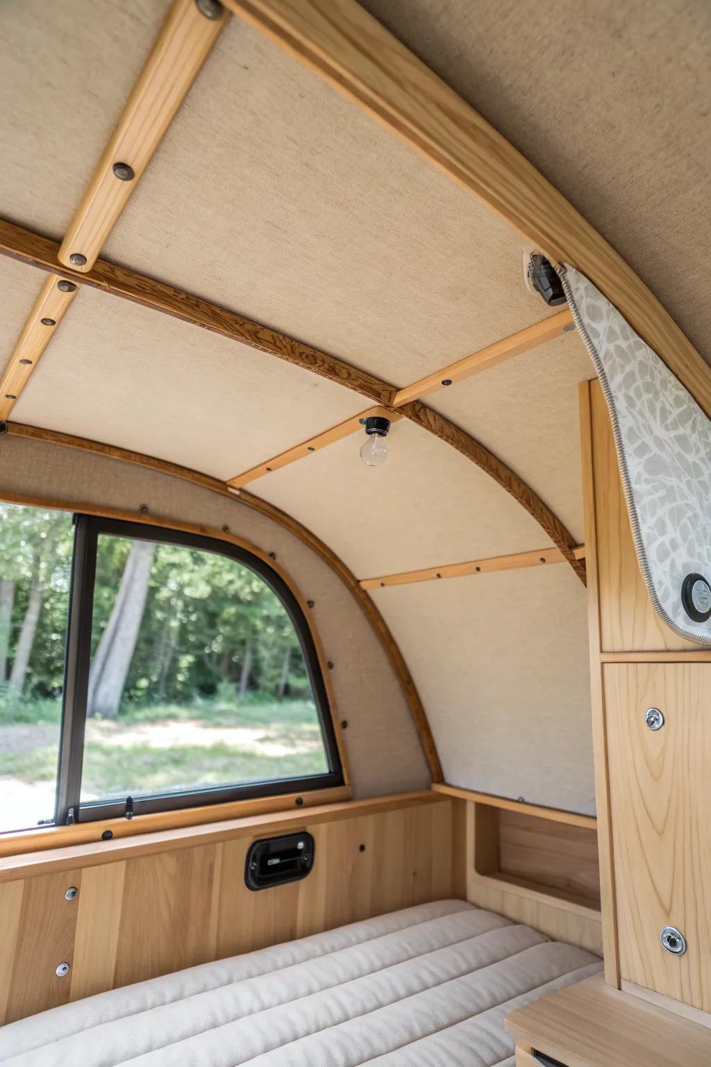 Soft fabric ceiling liner panel—natural oak + linen texture to calm echo and warm the cabin.
