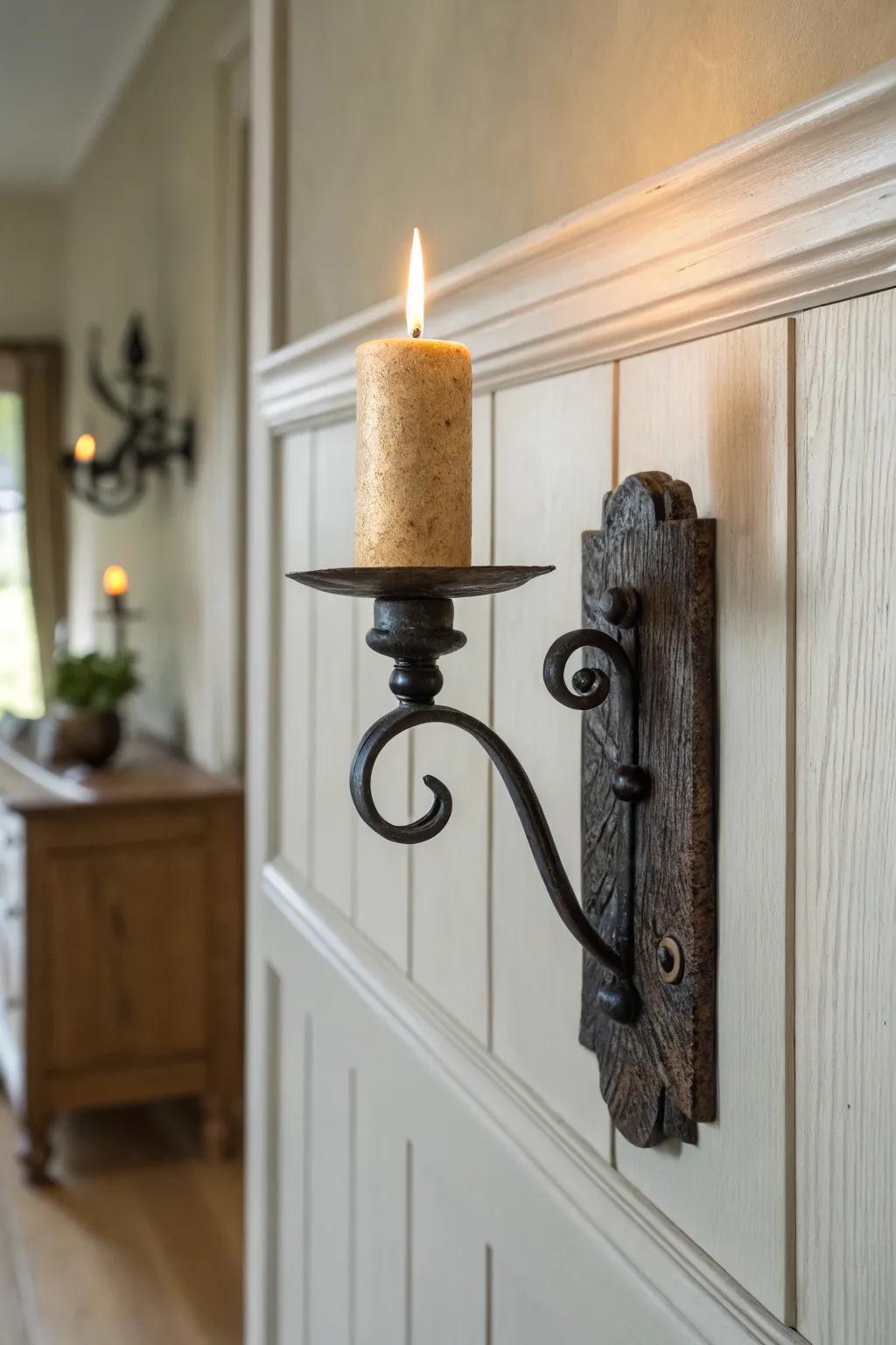Warm candle sconces soften colonial wainscoting with layered, flickering light at night.