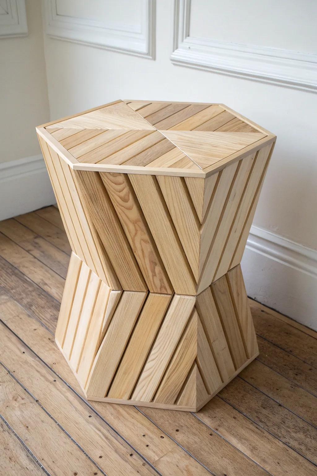 Sculptural hexagon block stool—simple angled cuts, striking geometry, and warm natural wood.