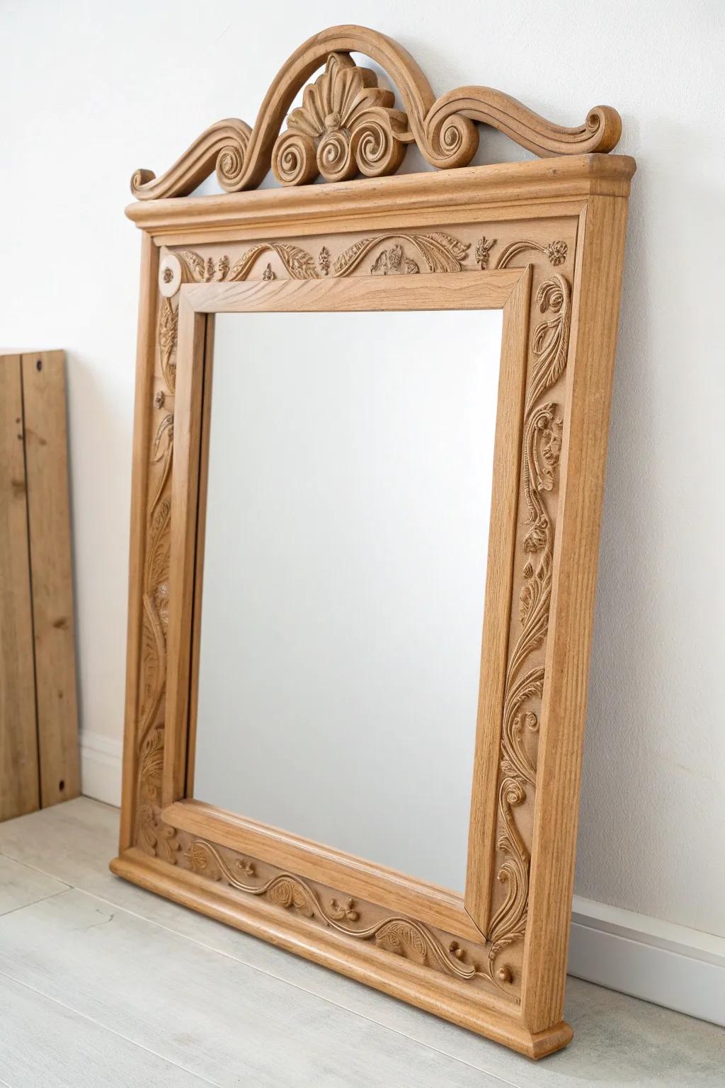Old headboard trim, new purpose: a carved wood vanity mirror frame with clean Scandinavian calm.