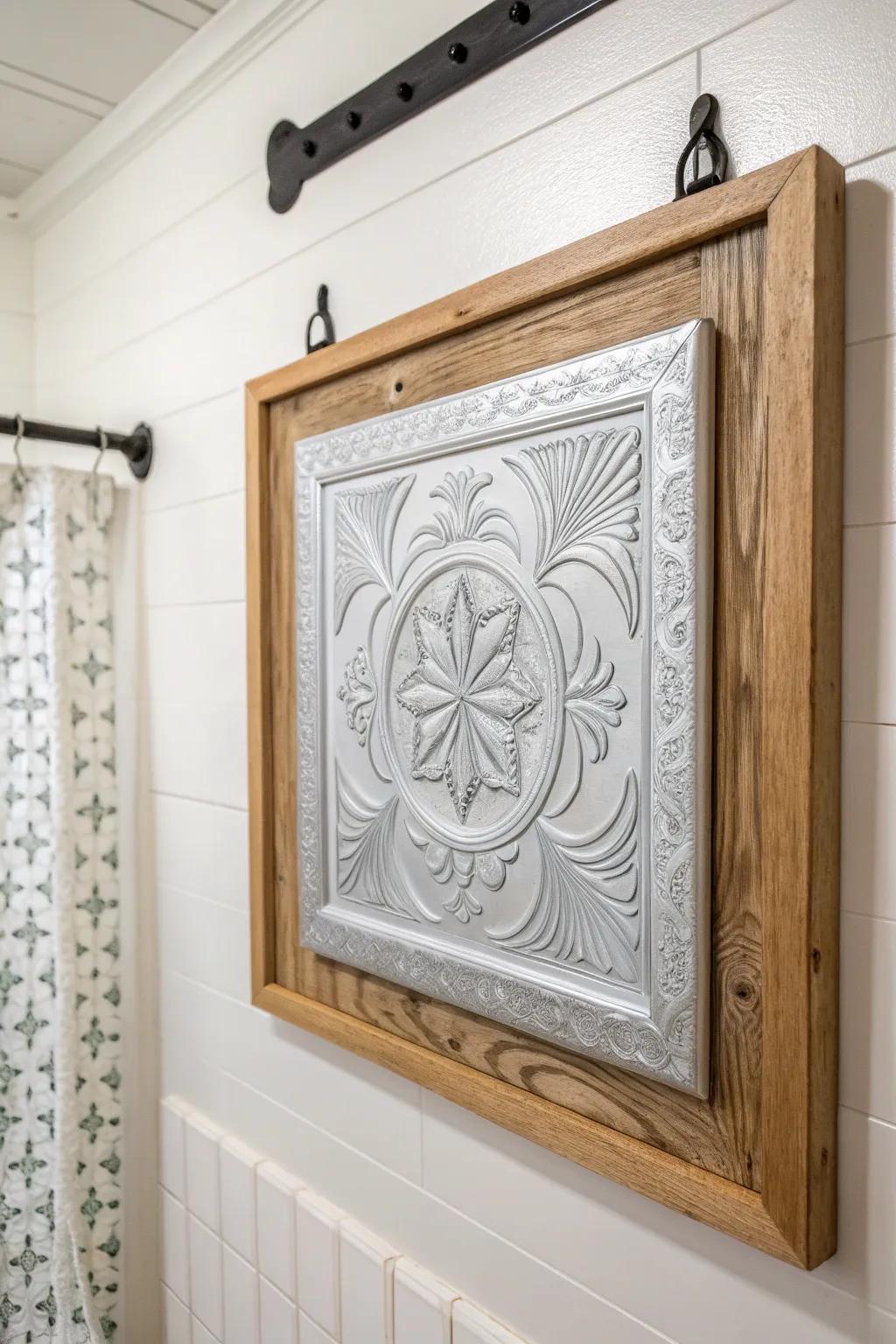 Framed embossed tin tile art adds vintage farmhouse texture with bold wood-and-black contrast.