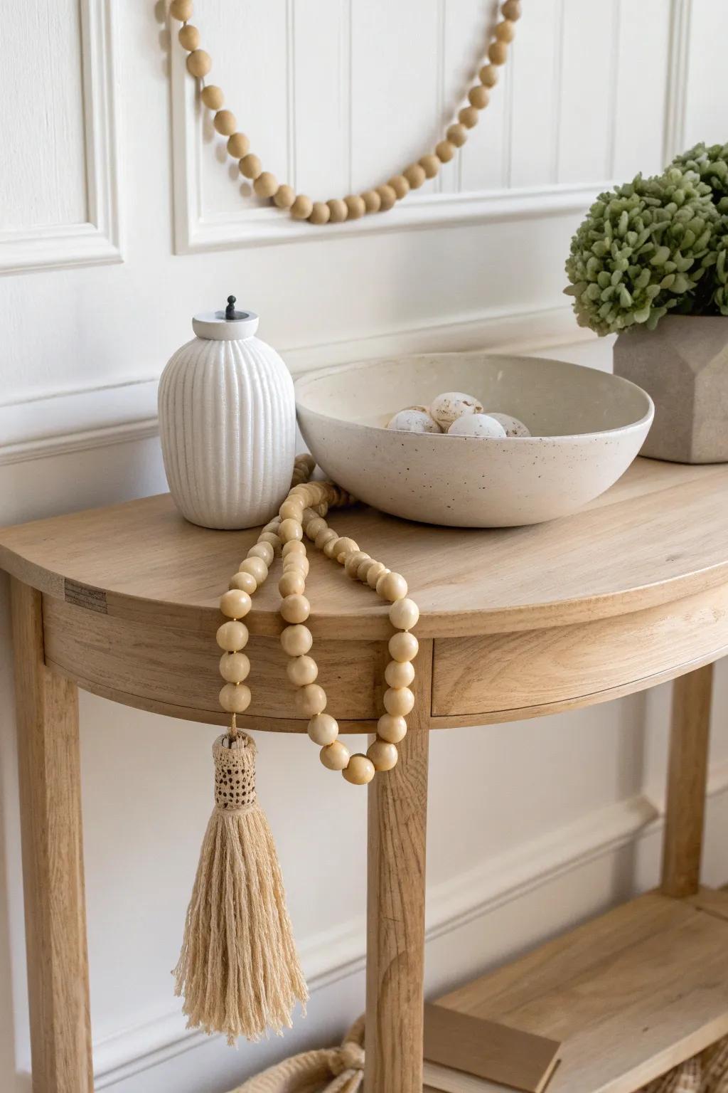 Natural wood bead garland draped over a ceramic bowl for effortless half-moon table charm.