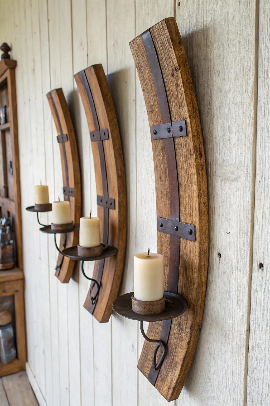 Curved barrel staves turned into a sculptural candle sconce trio—warm wood, brass, and glow.