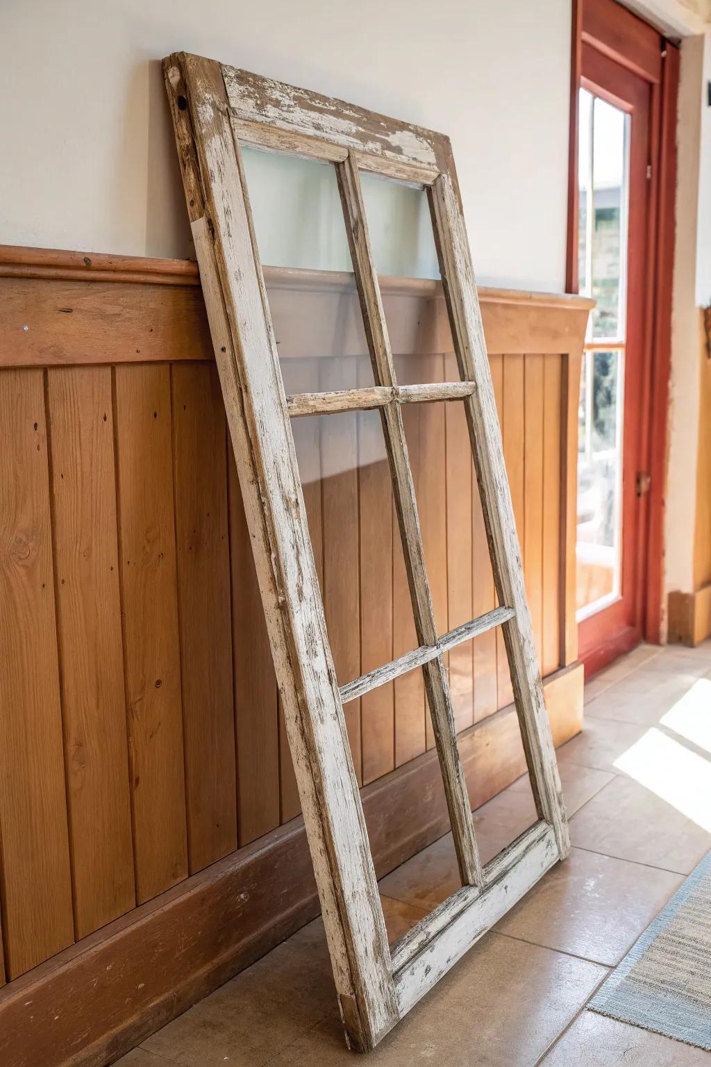 Weathered salvaged window frame wall art—simple, storied farmhouse charm above the entry.