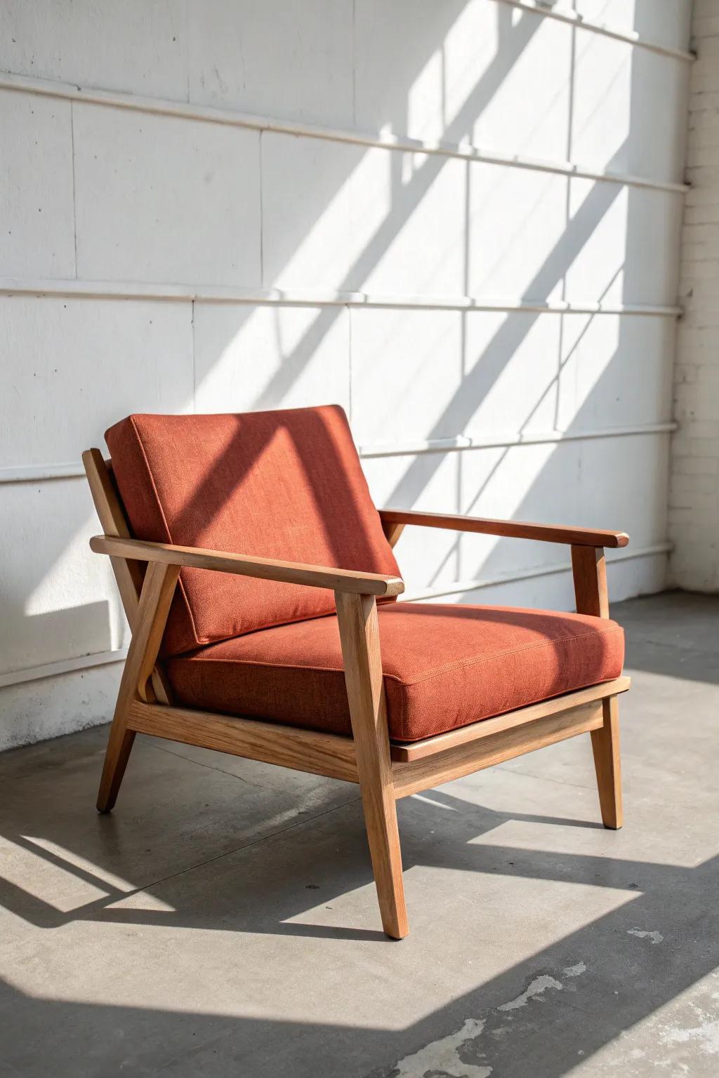 Modern angled oak lounge chair—clean lines, bold terracotta linen, and warm handcrafted charm.