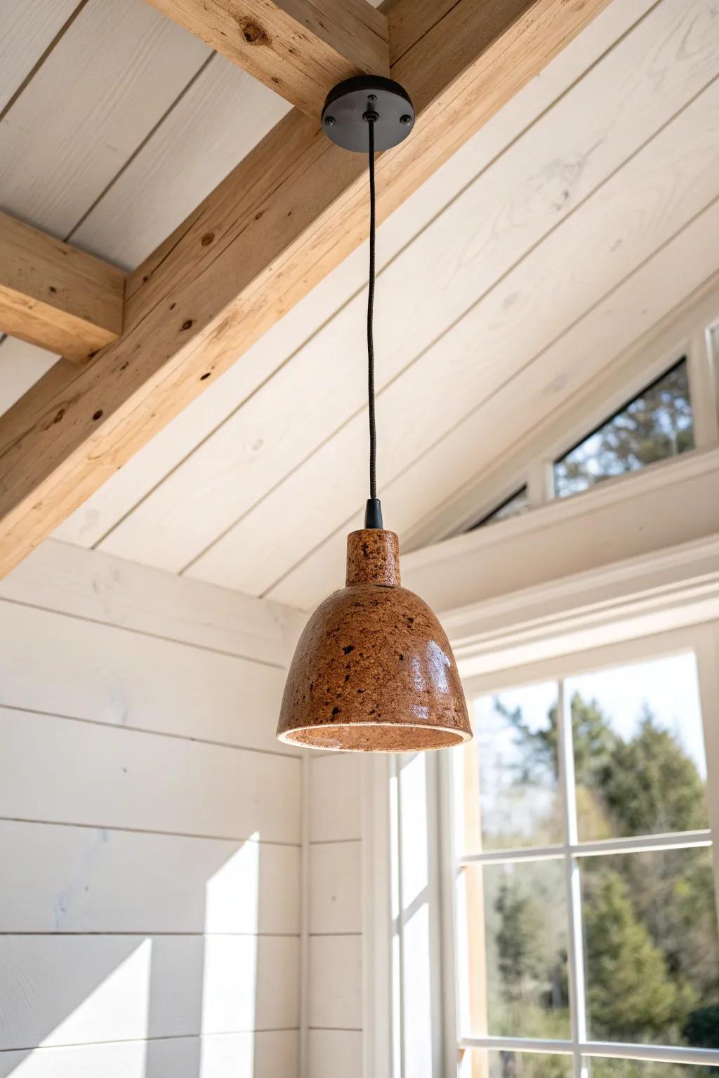 Cozy tiny-house dining nook: a single bold pendant dropped from the ridge beam for warmth.
