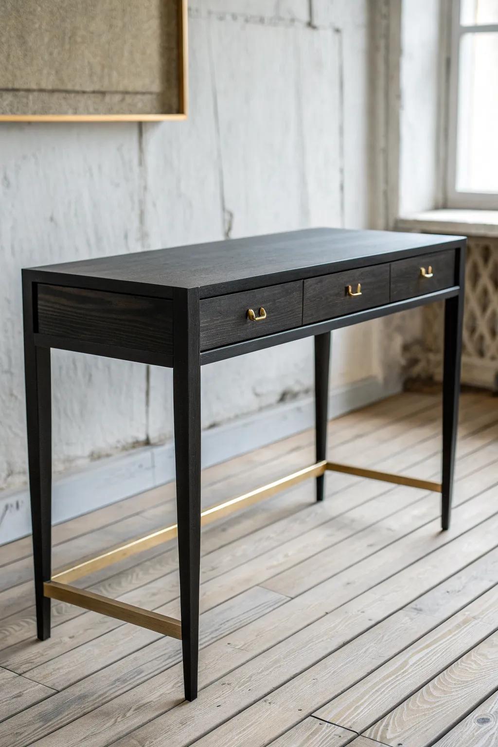Black wood desk with warm brass accents—minimal, high-contrast, softly glowing in daylight.
