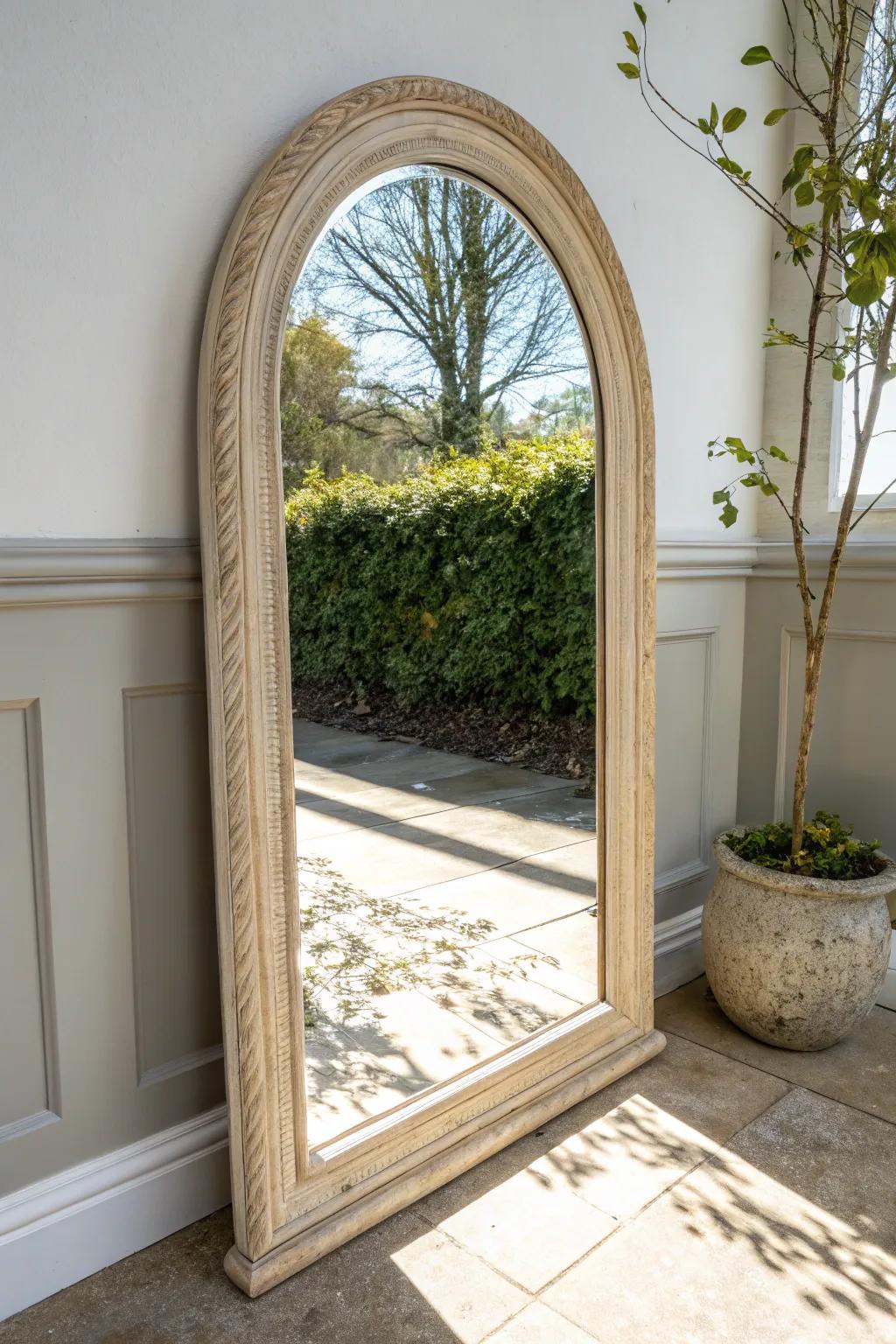 A faux arched niche around a mirror adds instant French farmhouse charm—simple, soft, and refined.