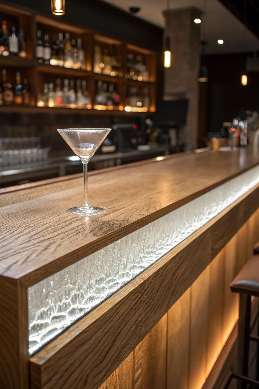 Backlit textured glass transforms an oak bar top into warm, modern mood lighting.