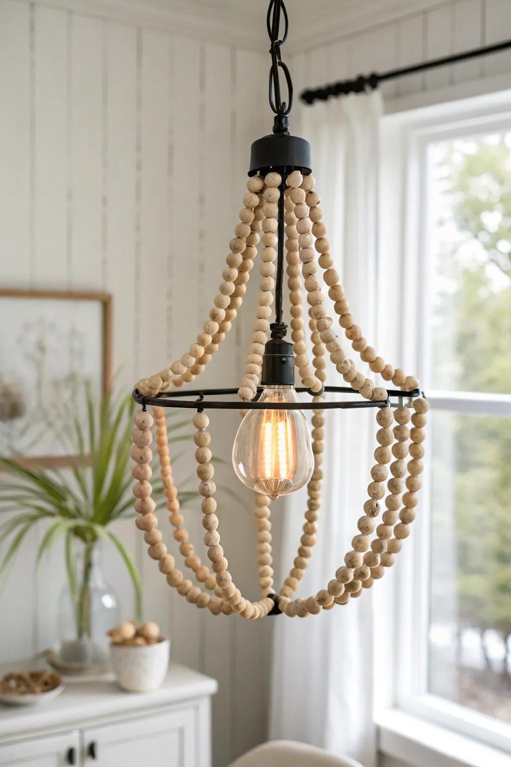 Cascading wooden bead strands add airy boho charm to a minimalist pendant light.