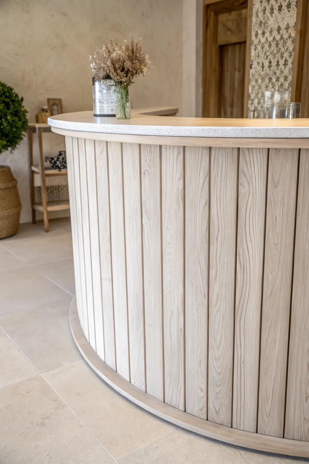 Curved shiplap boards wrap the bar front for a soft, custom look with modern Scandinavian warmth.