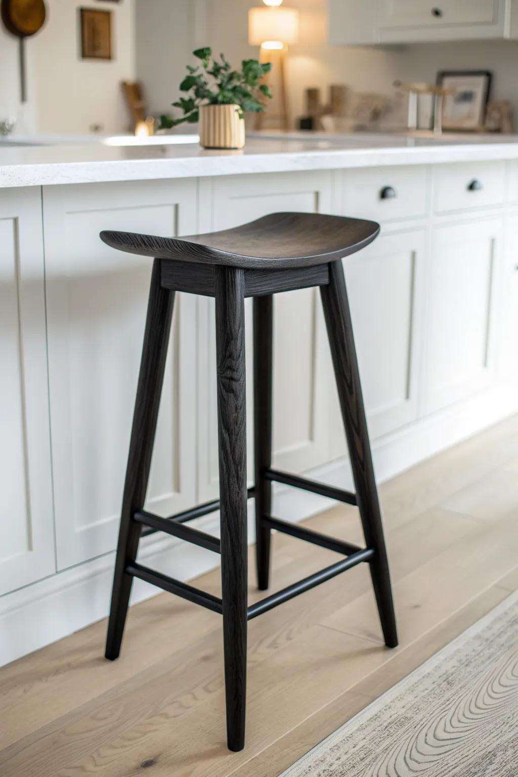 Matte-black wooden bar stool: crisp, modern contrast that frames a bright white kitchen.