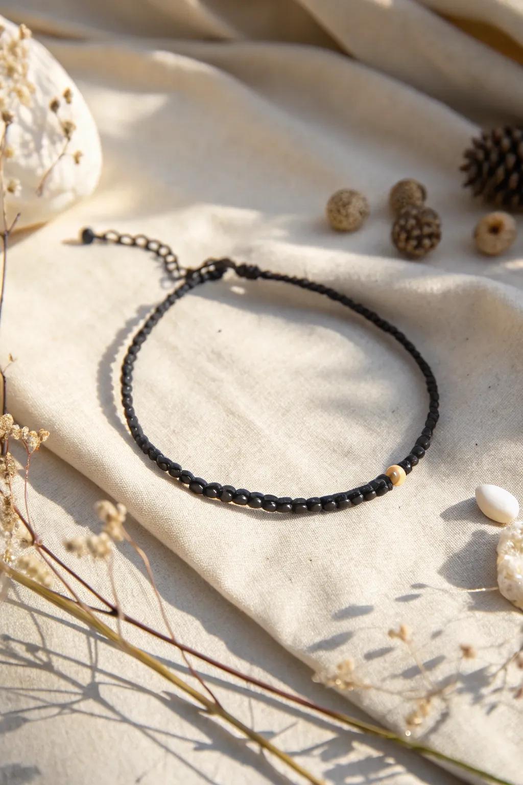Embrace the subtle charm of handcrafted elegance with this minimalist black thread anklet.