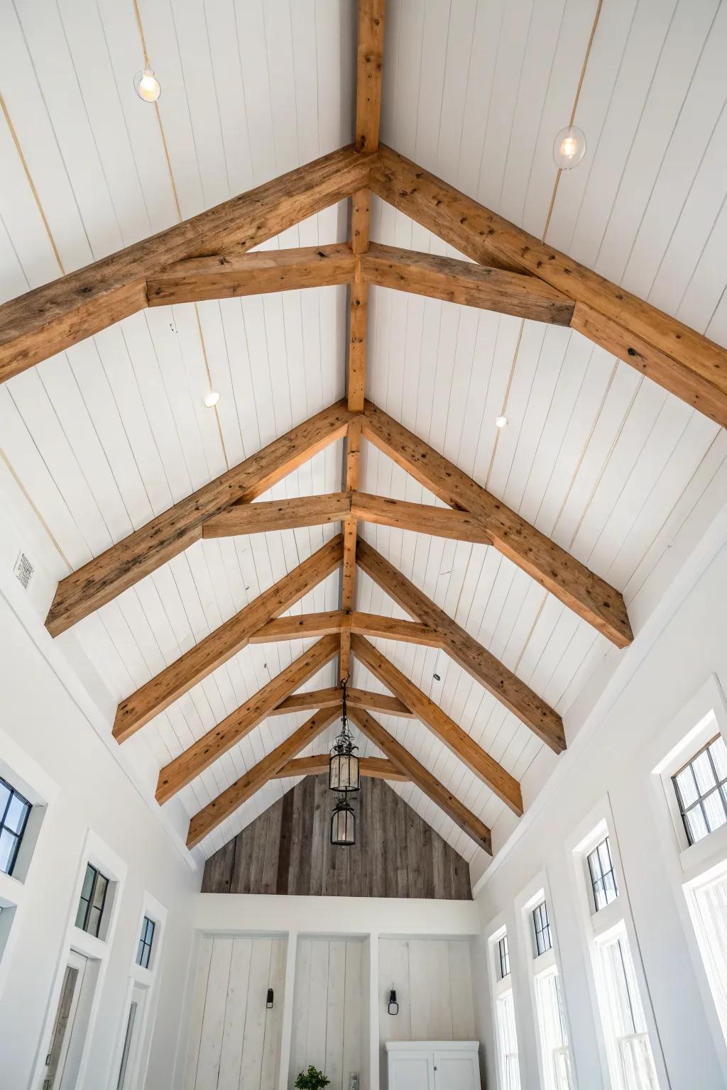 A reclaimed-wood faux beam brings modern farmhouse warmth to a crisp white vaulted ceiling.