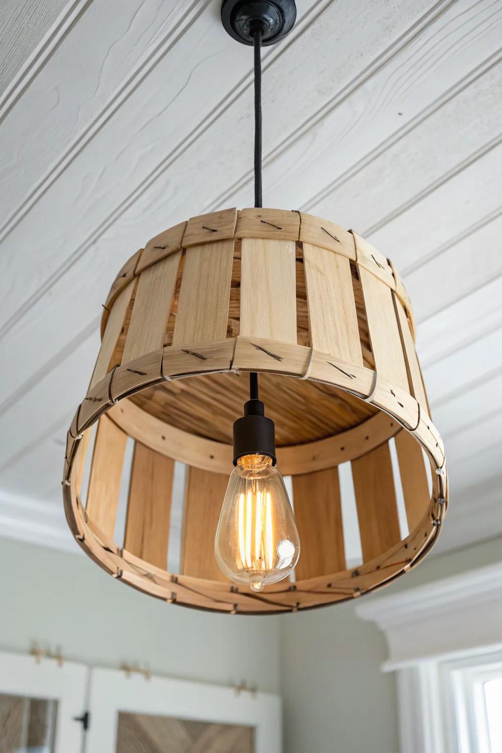 DIY bushel basket pendant shade—warm, striped glow and cozy cabin charm in a minimalist space.