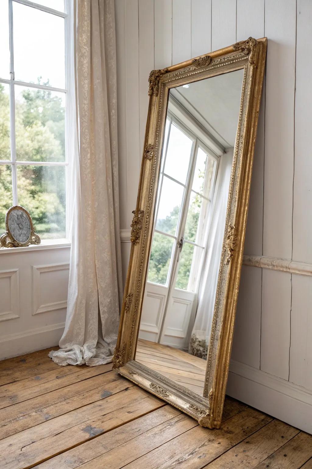 Soft-gold ornate mirror leaned casually—French cottage charm with Scandinavian calm.