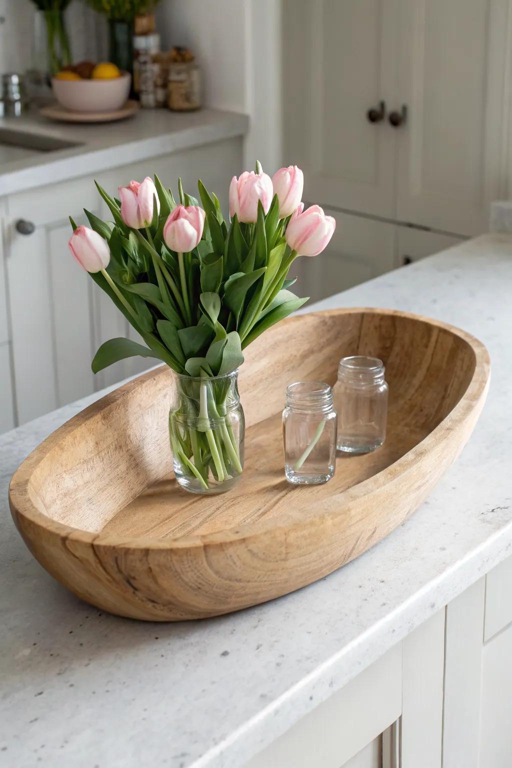 Pink tulips in simple jars tucked into a wooden dough bowl—effortless Valentine charm.