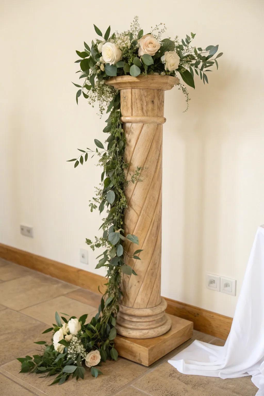 Spiral greenery up a warm oak pillar for a taller, photo-ready wedding ceremony look.