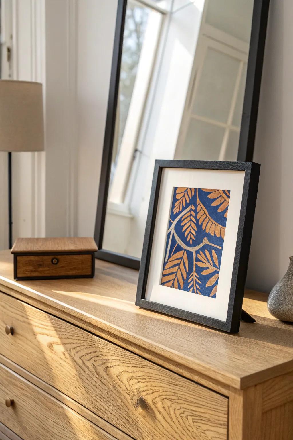 Layered charm: a framed photo leaning on the mirror for effortless vintage dresser styling.