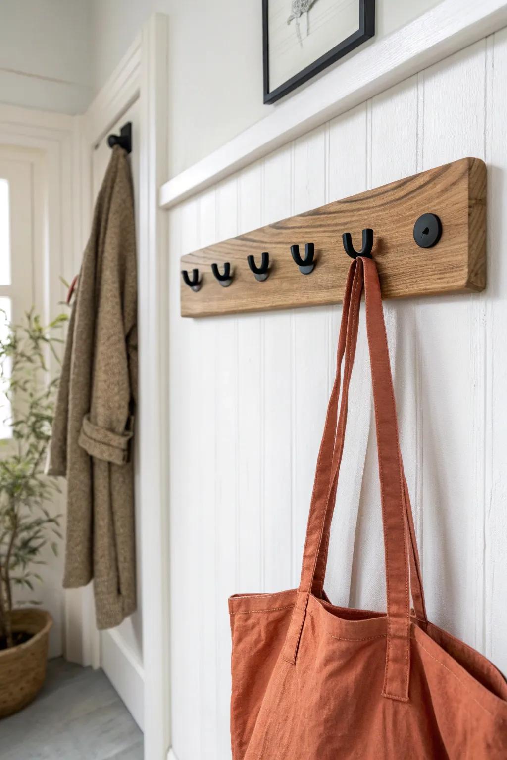 Reclaimed-wood peg rail with matte-black hooks—minimal, warm, and perfectly practical.