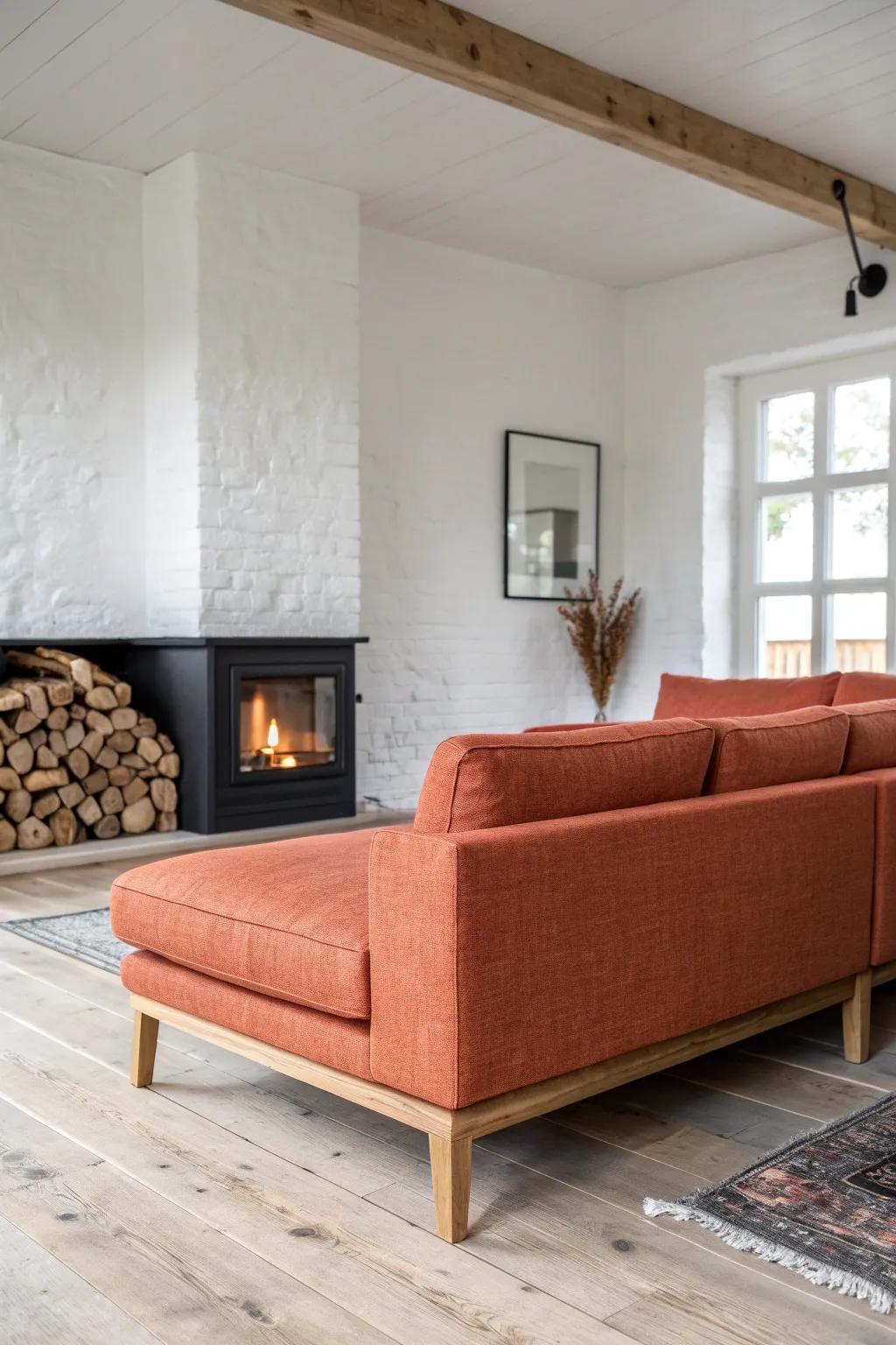 Terracotta sectional hugs the hearth—Scandi-clean lines, oak craftsmanship, and cozy boho texture.