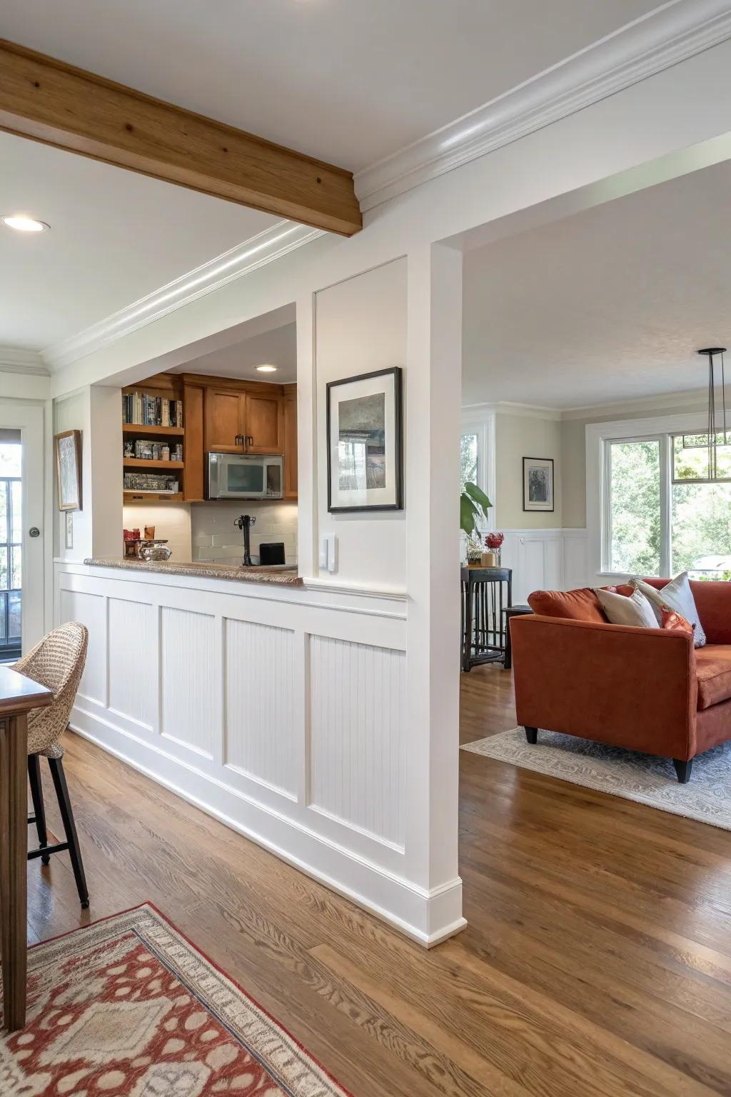 Picture-frame wainscoting turns a half wall into a built-in feature—clean, bold, and warm.