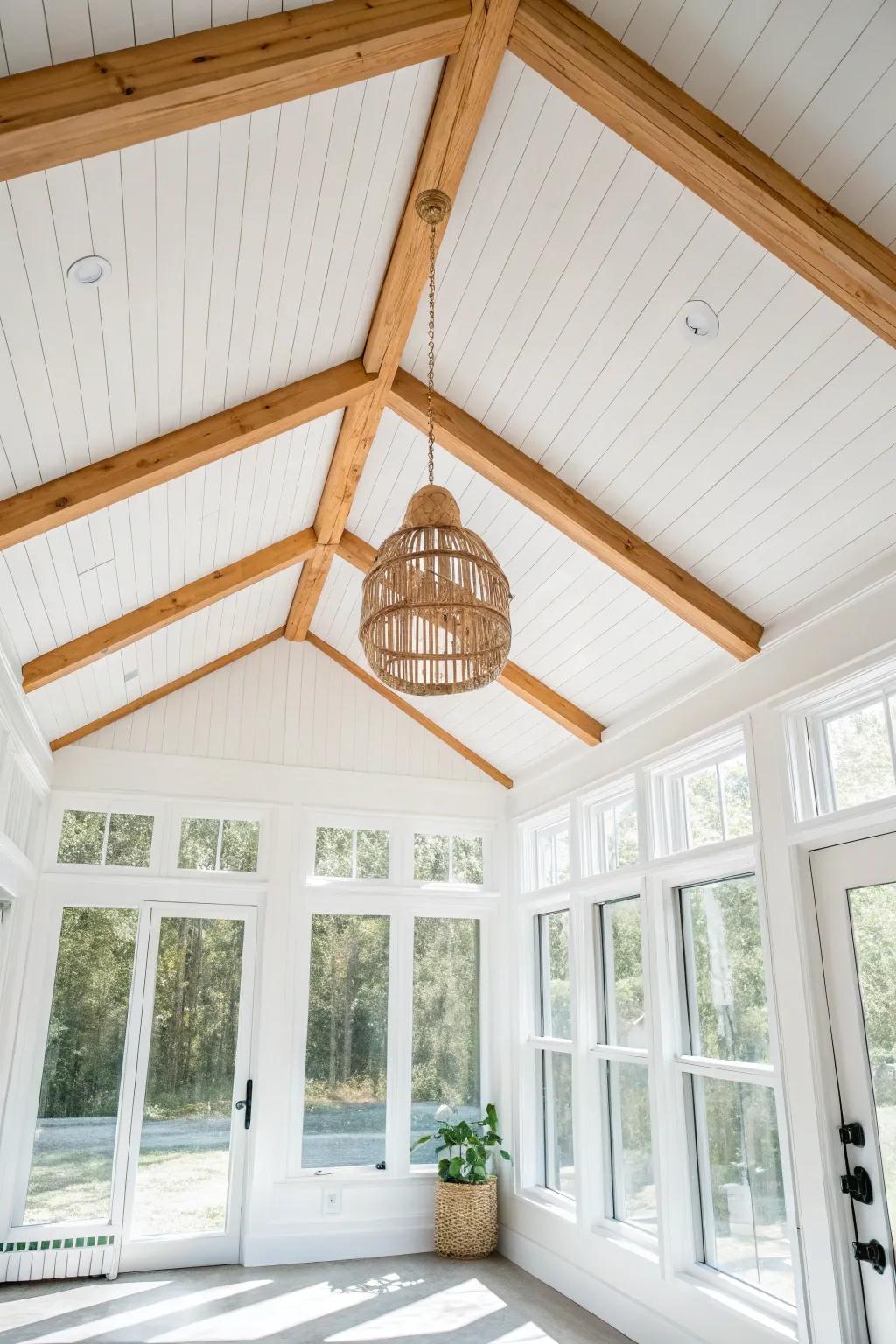 White shiplap vault + one warm wood beam: the perfect cozy contrast for a sunroom.