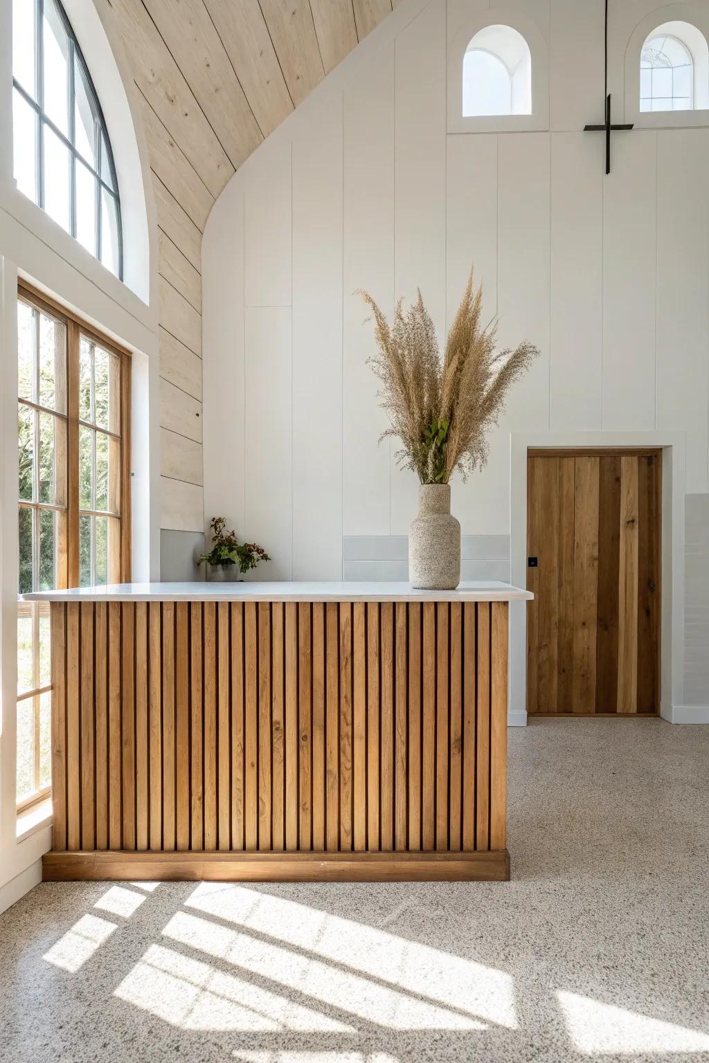 Warm reclaimed wood slat wall behind a clean welcome counter—modern, calm, and inviting.