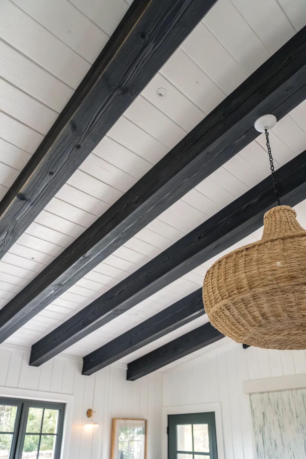 Charcoal-painted beams against white boards—an easy, high-contrast ceiling upgrade with drama.