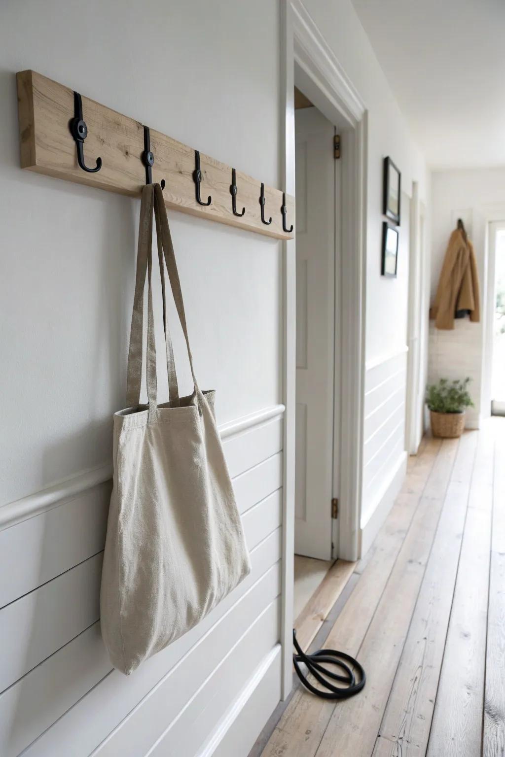 A slim oak hook rail keeps bags and leashes flat—clean, calm storage for narrow hallways.