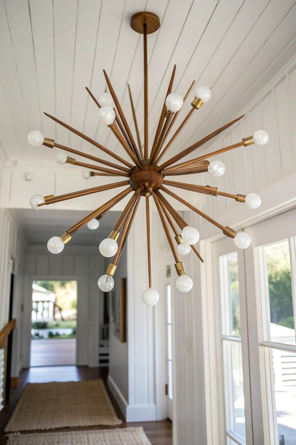 A walnut-and-brass starburst chandelier that turns a minimal entryway into a statement.