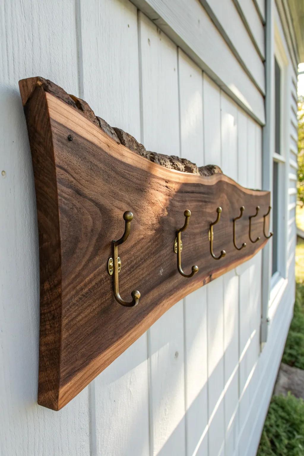 Live-edge black walnut coat rack—swirling grain and brass hooks for a calm, crafted entry.