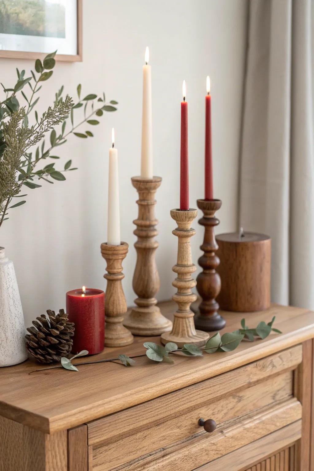 Cluster mismatched candlesticks in varied heights for a bold, cozy Christmas sideboard moment.