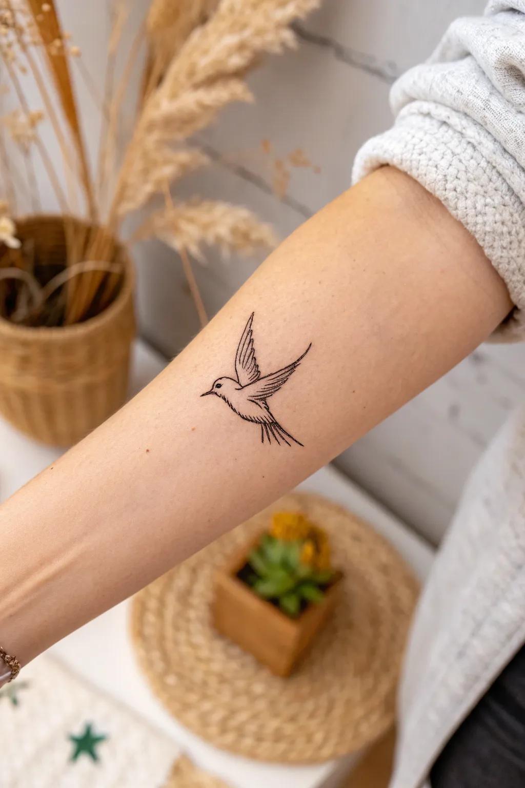 Embrace freedom with a minimalist bird tattoo that speaks volumes in simplicity.