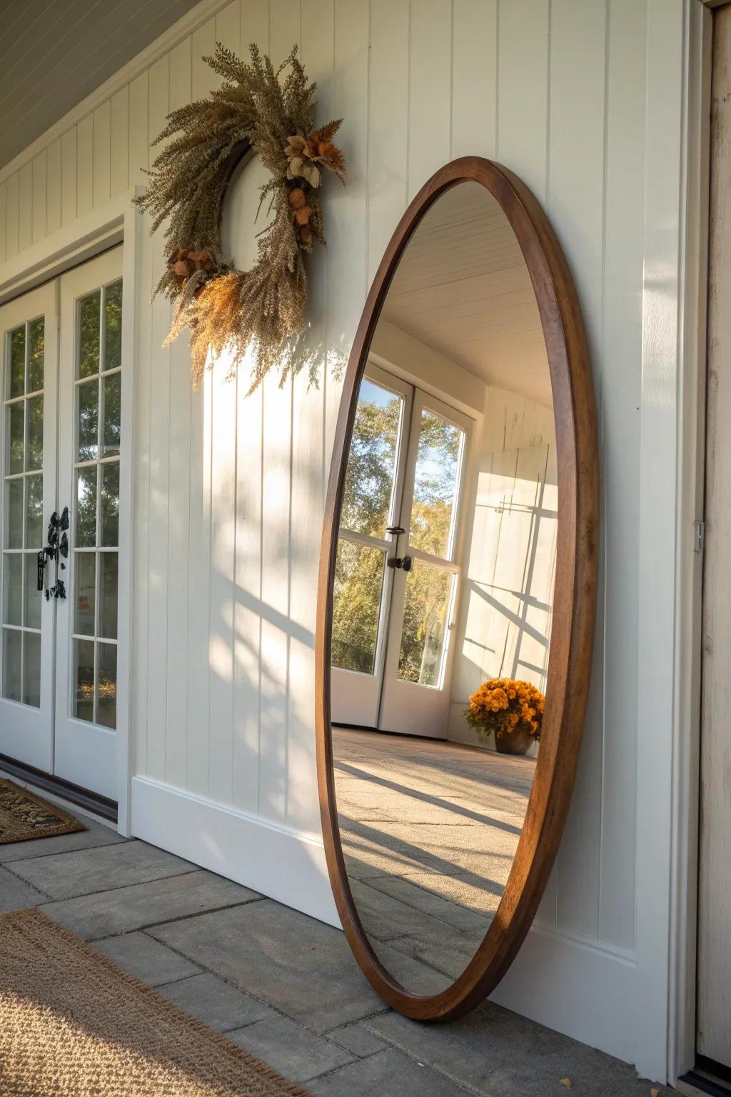 A walnut-framed mirror with a tiny fall wreath—brightens the foyer and feels effortlessly cozy.