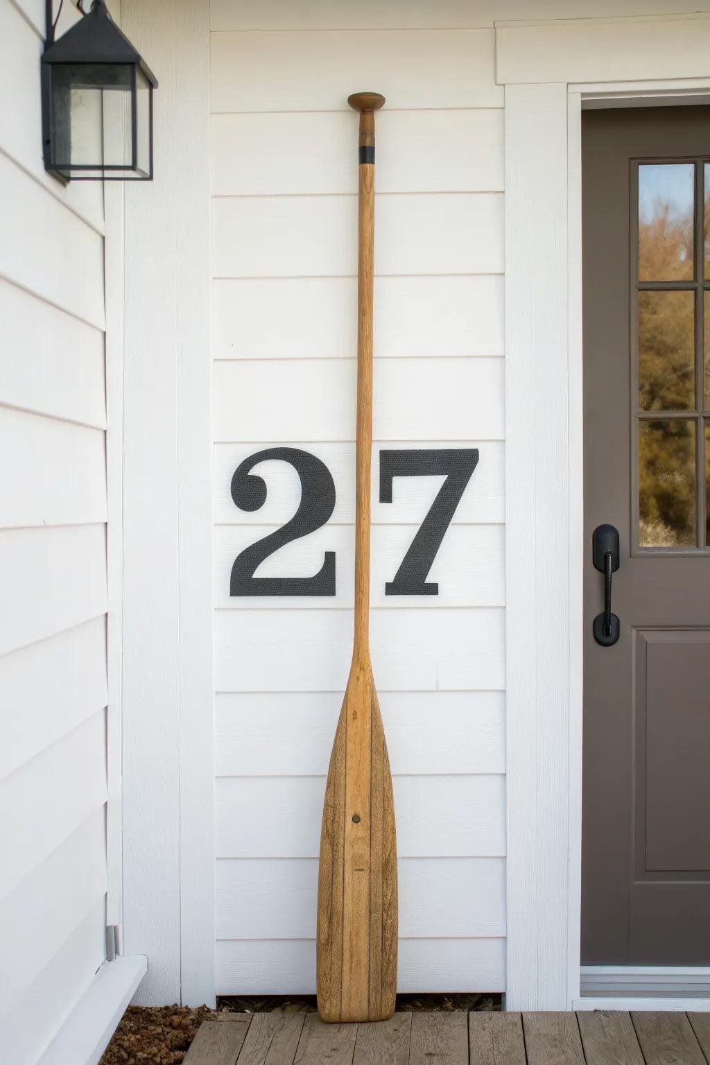 Vertical oar address sign with bold numbers—minimal, coastal, and easy to spot from the street.