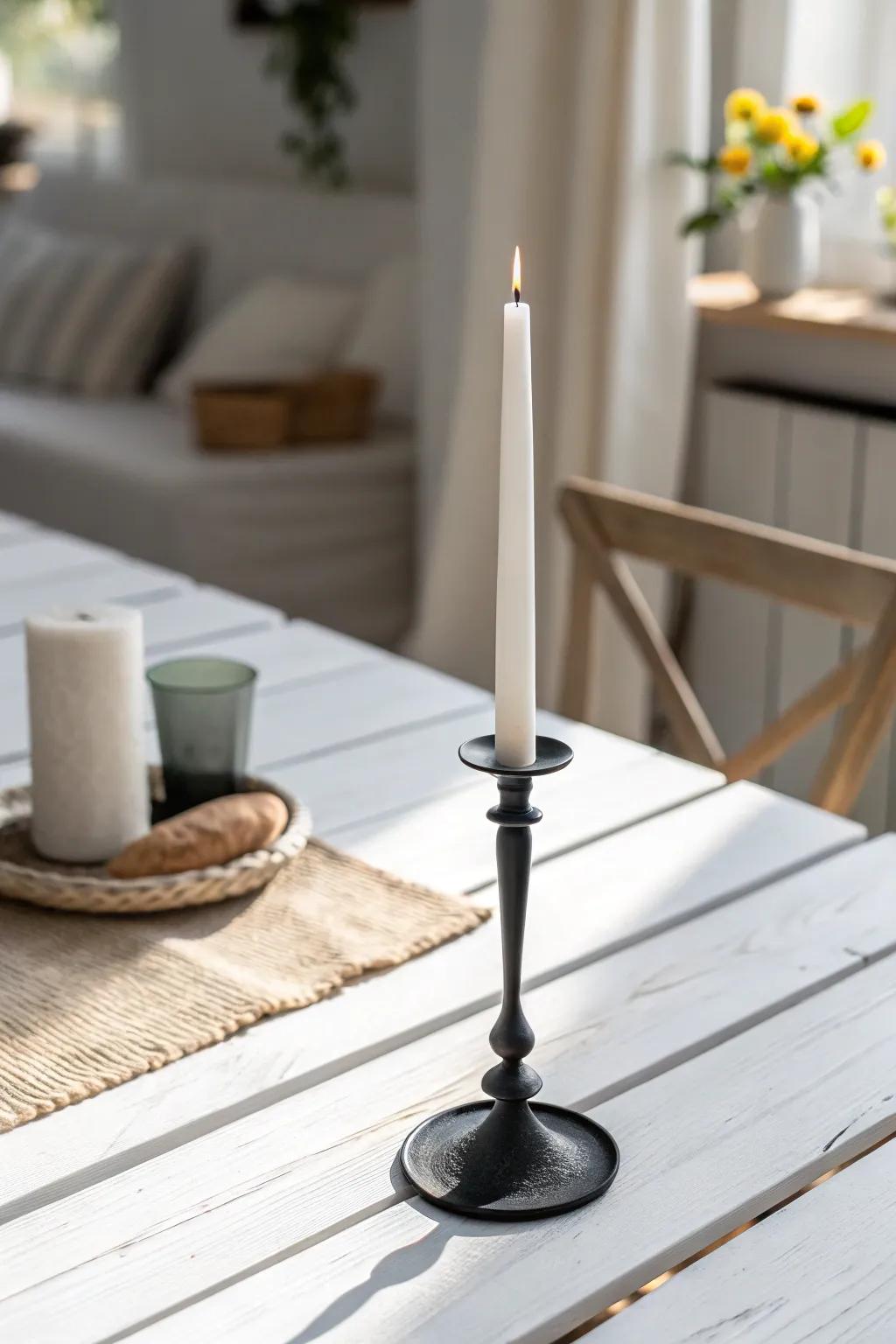 A slim black candlestick adds crisp contrast—grounding a white dining table with ease.